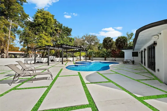 a view of a patio with a table and chairs under an umbrella