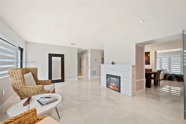 a view of a livingroom with a fireplace and window