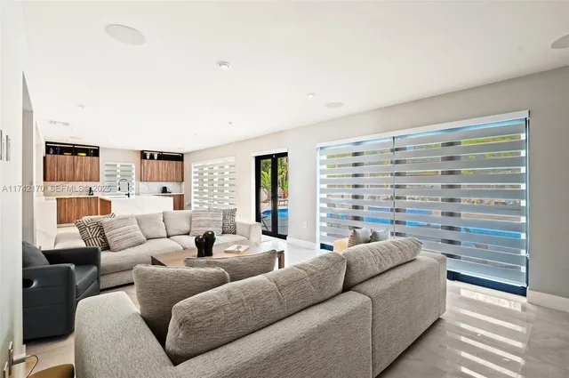 a living room with furniture and a large window