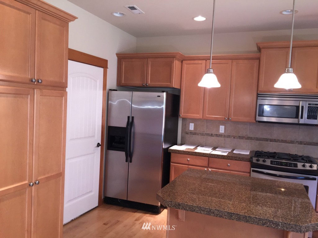 817 234th Place Southeast Bothell, WA 98021 - Photo 21 of 24 a kitchen with a refrigerator and a stove