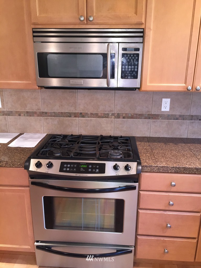 817 234th Place Southeast Bothell, WA 98021 - Photo 22 of 24 a stove top oven sitting inside of a kitchen