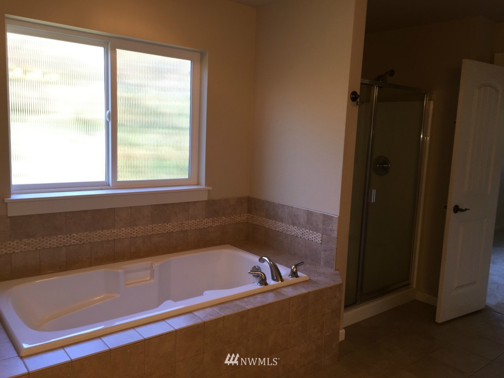 817 234th Place Southeast Bothell, WA 98021 - Photo 8 of 24 a bath tub sitting next to a window