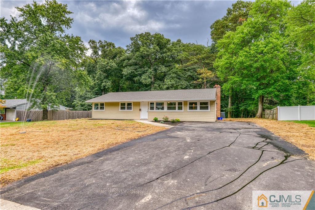 8 Halsey Road Kendall Park, NJ 08824 - Photo 1 of 30 a front view of a house with a yard and trees