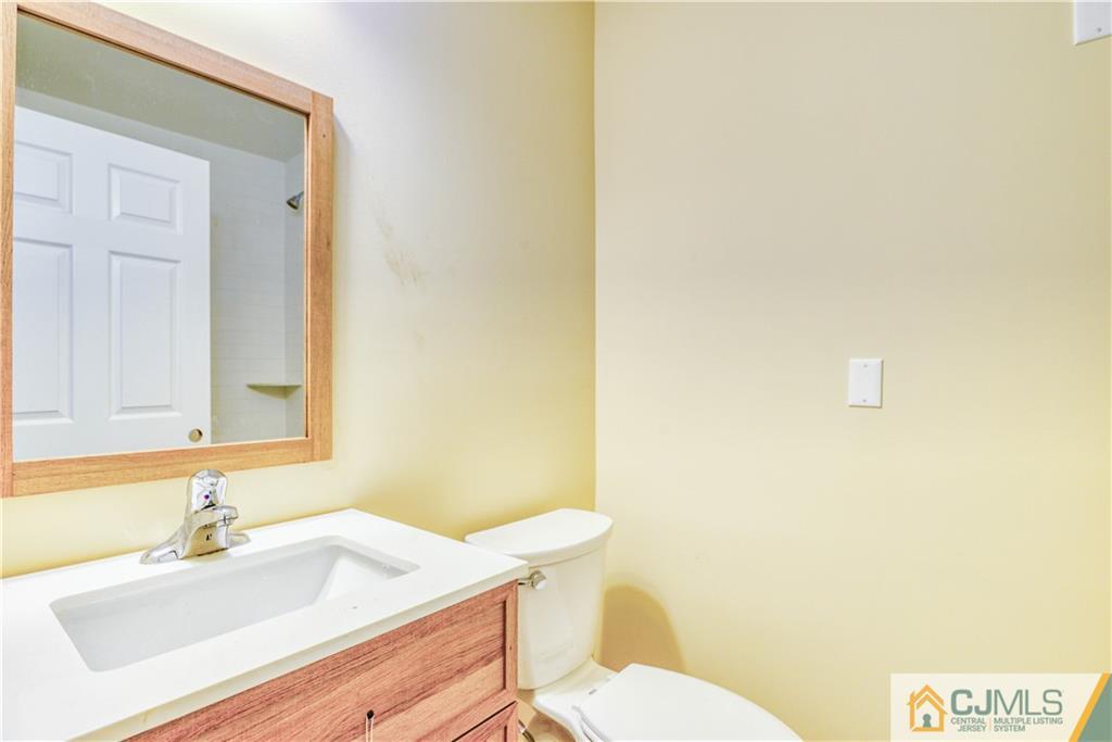 8 Halsey Road Kendall Park, NJ 08824 - Photo 12 of 30 a bathroom with a sink a toilet and mirror