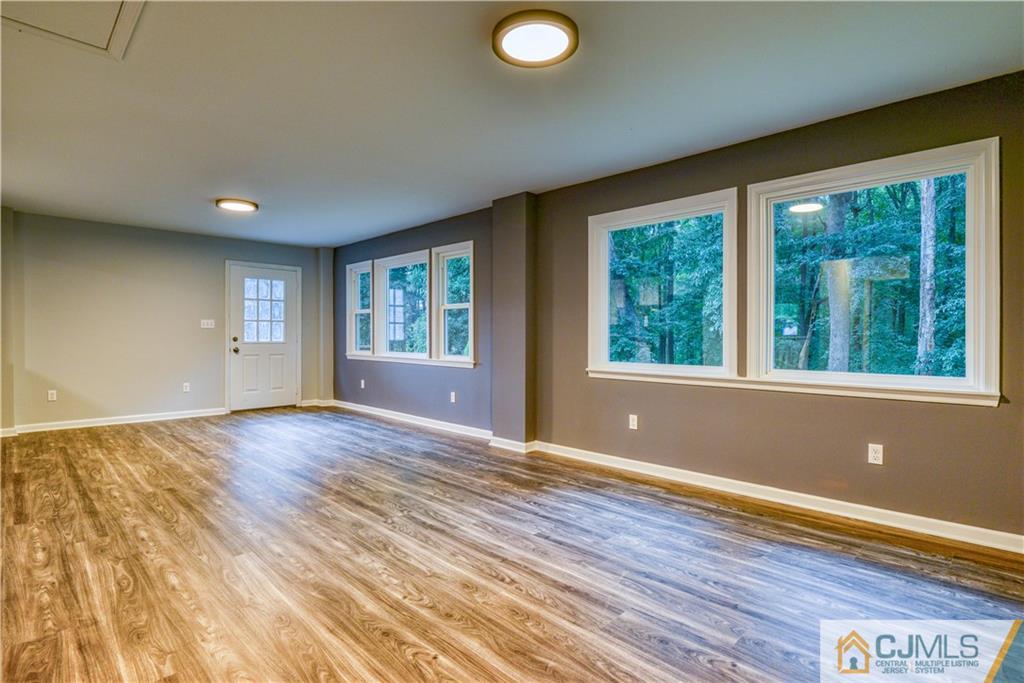 8 Halsey Road Kendall Park, NJ 08824 - Photo 20 of 30 a view of an empty room with wooden floor and a window