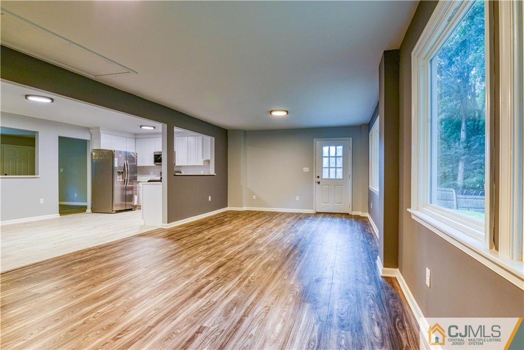 8 Halsey Road Kendall Park, NJ 08824 - Photo 21 of 30 a view of an empty room with wooden floor and a window