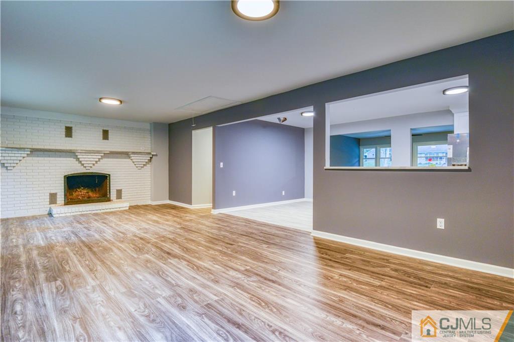 8 Halsey Road Kendall Park, NJ 08824 - Photo 23 of 30 a view of empty room with wooden floor and fireplace
