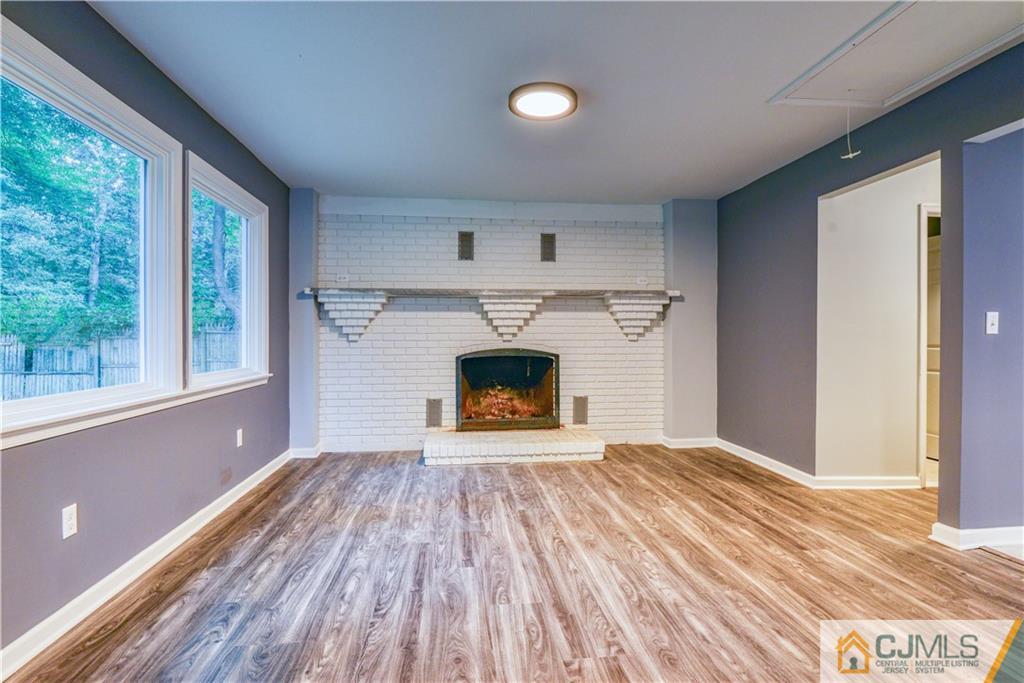 8 Halsey Road Kendall Park, NJ 08824 - Photo 24 of 30 a view of an empty room with a window and fireplace