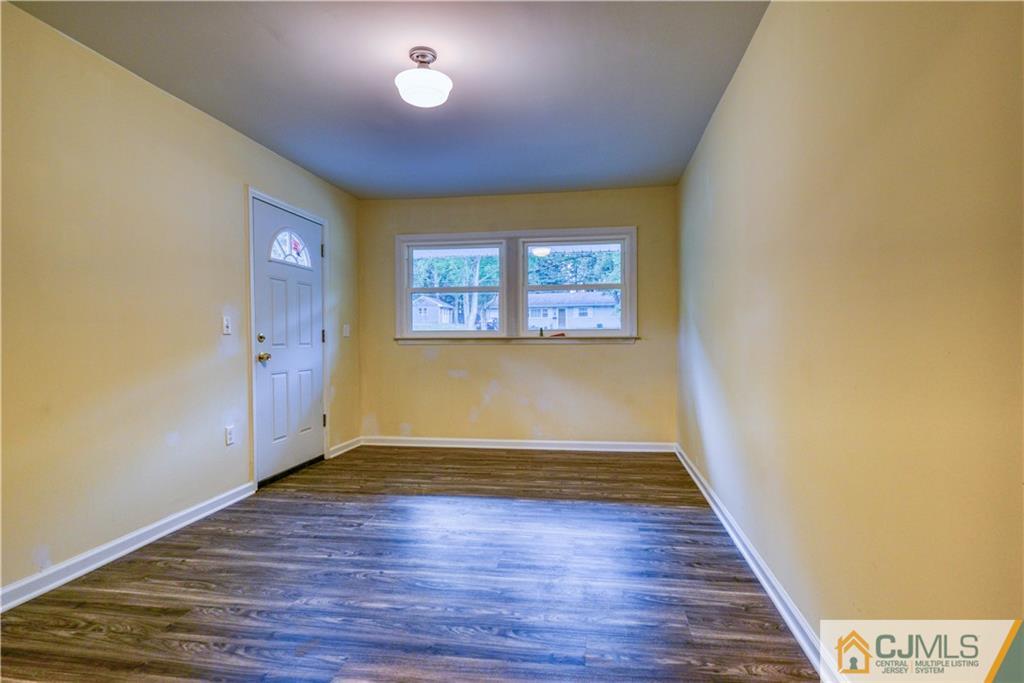 8 Halsey Road Kendall Park, NJ 08824 - Photo 25 of 30 an empty room with wooden floor and windows