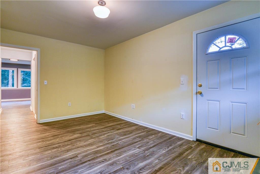 8 Halsey Road Kendall Park, NJ 08824 - Photo 26 of 30 wooden floor in an empty room with a window
