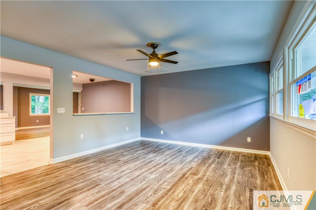 8 Halsey Road Kendall Park, NJ 08824 - Photo 4 of 30 a view of an empty room and window and wooden floor