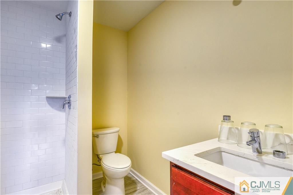 8 Halsey Road Kendall Park, NJ 08824 - Photo 10 of 30 a bathroom with a sink and a toilet