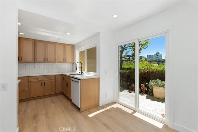 a kitchen with a refrigerator and a sink