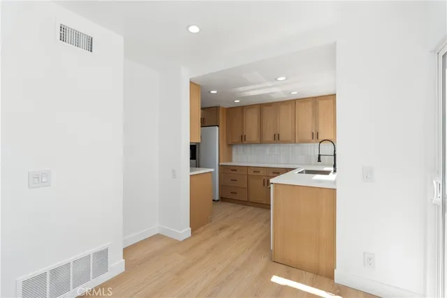 a kitchen with granite countertop a sink and a stove top oven