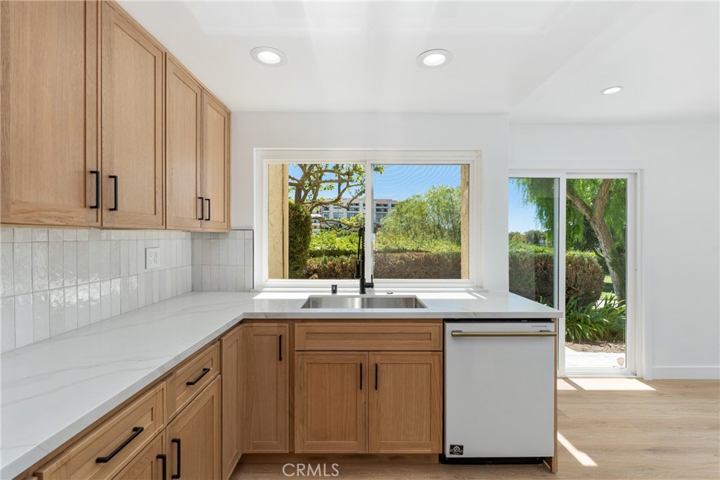 15 Hilltop Circle Rancho Palos Verdes, CA 90275 - Photo 15 of 40 a kitchen with granite countertop white cabinets and a large window