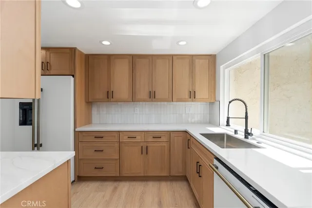 a kitchen with a sink cabinets and stainless steel appliances