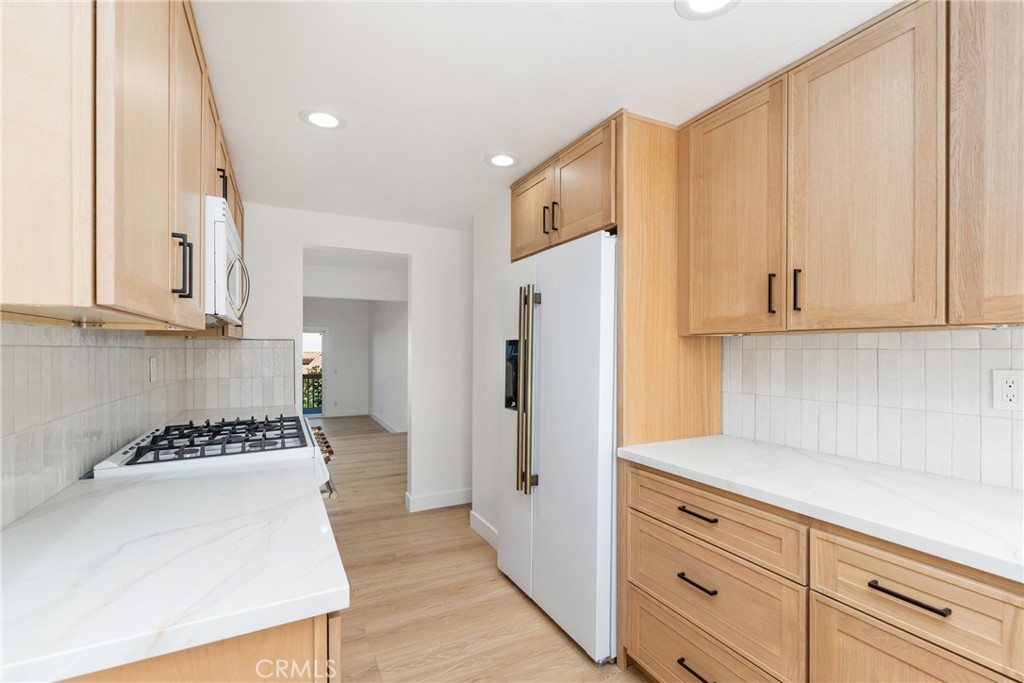 15 Hilltop Circle Rancho Palos Verdes, CA 90275 - Photo 17 of 40 a kitchen with white cabinets and refrigerator