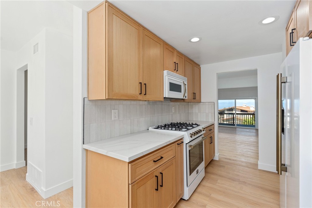 15 Hilltop Circle Rancho Palos Verdes, CA 90275 - Photo 18 of 40 a kitchen with stainless steel appliances granite countertop a stove and a refrigerator