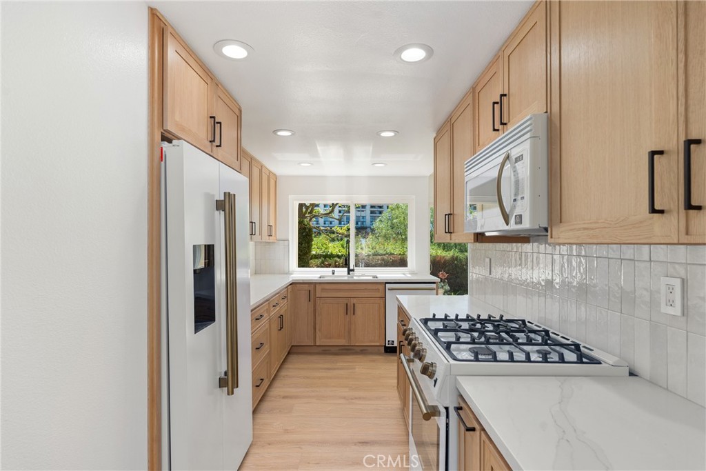 15 Hilltop Circle Rancho Palos Verdes, CA 90275 - Photo 19 of 40 a kitchen with white cabinets and appliances