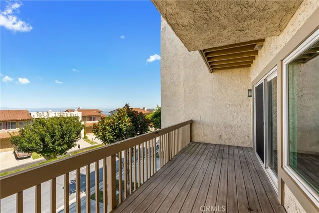 a view of a balcony with wooden floor