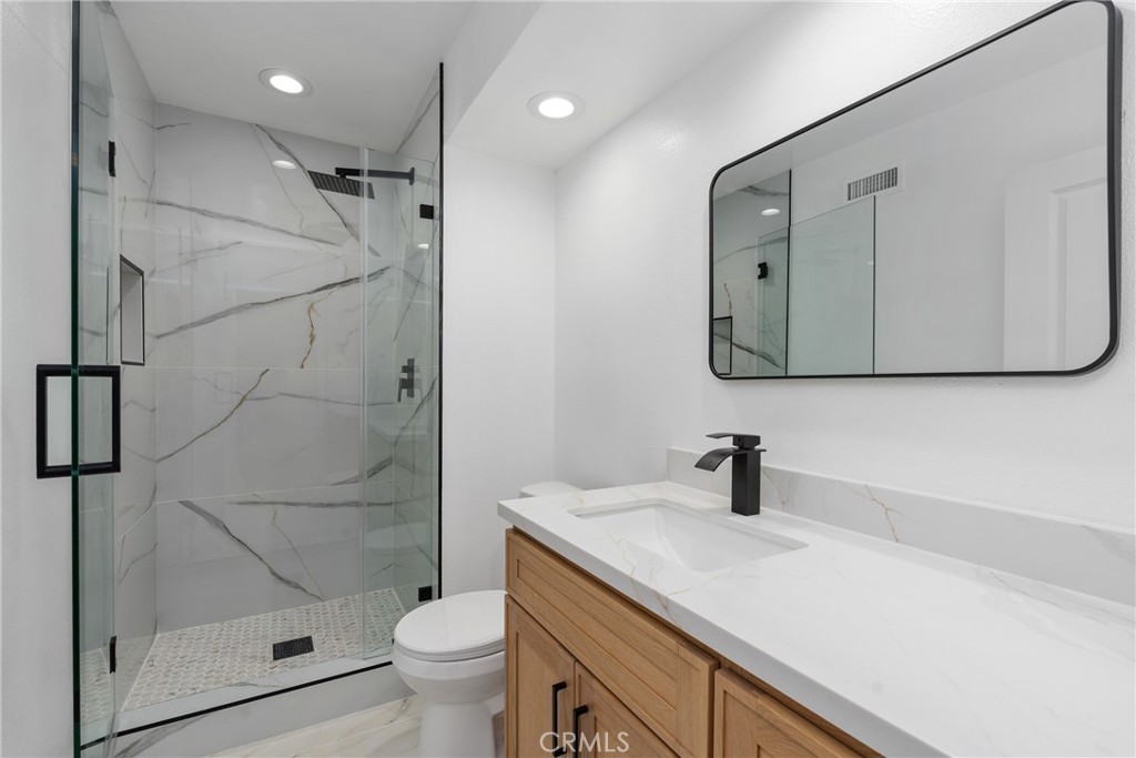 15 Hilltop Circle Rancho Palos Verdes, CA 90275 - Photo 30 of 40 a bathroom with a shower sink vanity mirror and toilet