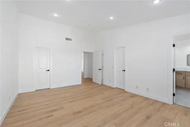 a spacious bathroom with a shower sink and mirror