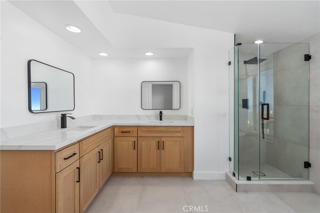 15 Hilltop Circle Rancho Palos Verdes, CA 90275 - Photo 35 of 40 a spacious bathroom with a shower sink and mirror