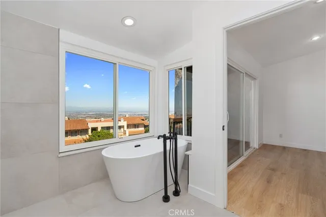 a view of a bathroom with a tub and window