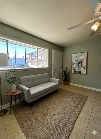 a living room with furniture and a large window