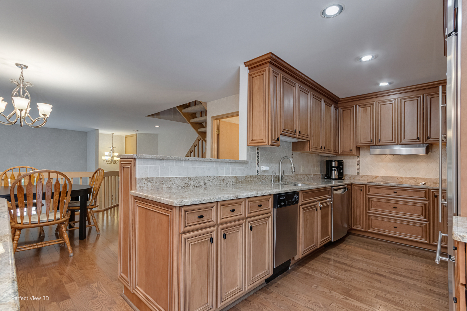 1020 Deerfield Road Highland Park, IL 60035 - Photo 6 of 29 a kitchen that has cabinets a sink stainless steel appliances and dining table
