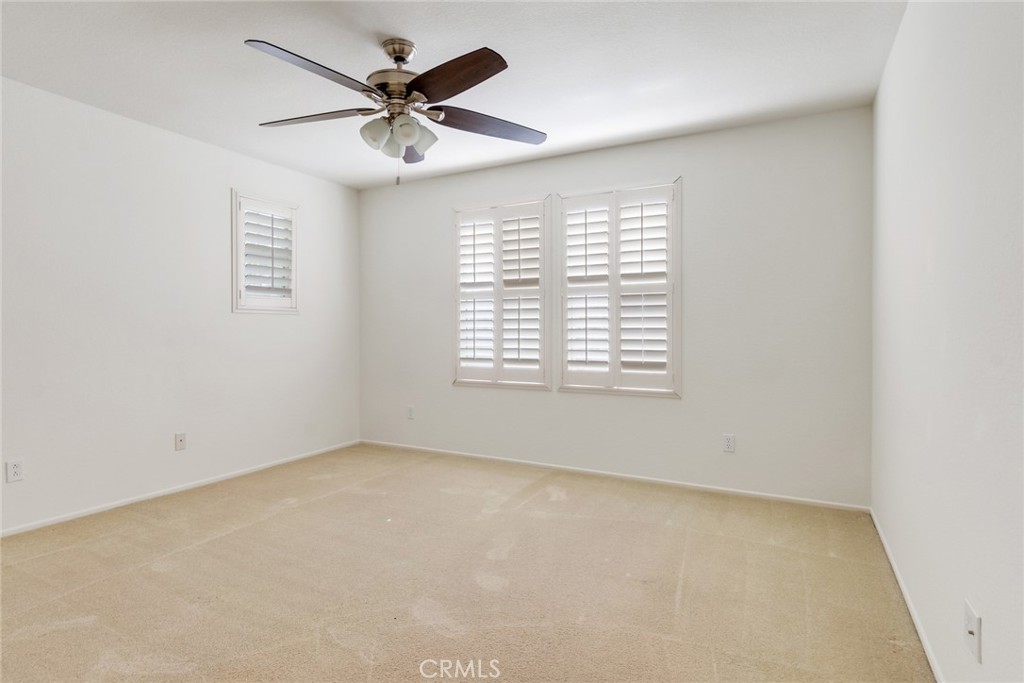 9140 Village Way Riverside, CA 92508 - Photo 18 of 37 an empty room with a window and a ceiling fan