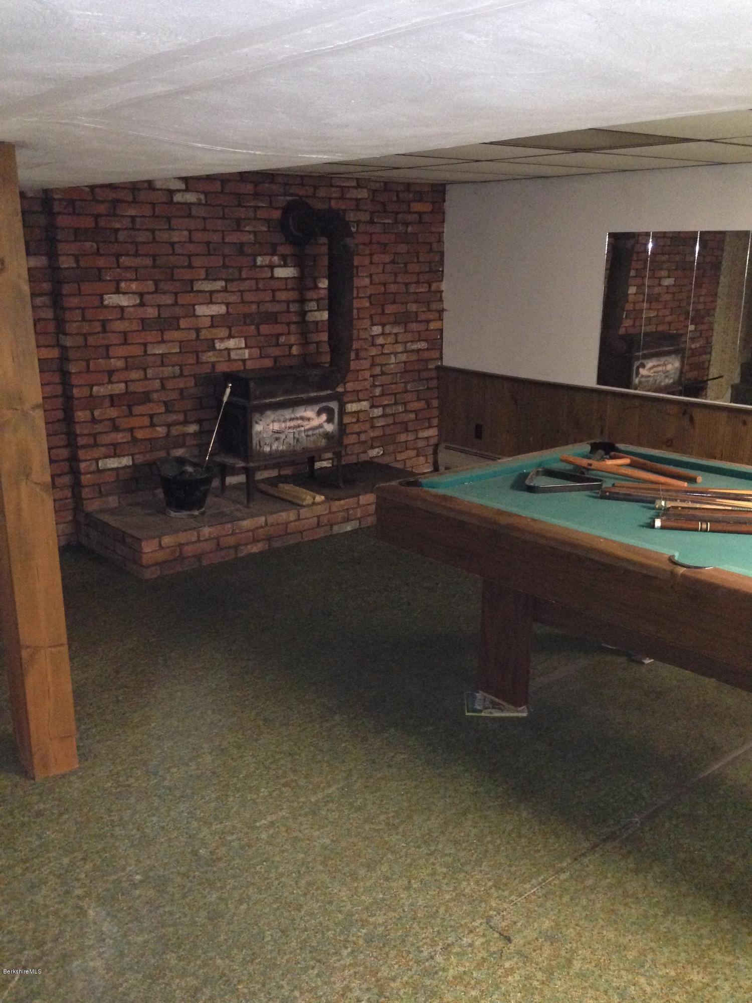 94 Ingalls Road Cheshire, MA 01225 - Photo 16 of 25 Lower Level Family Room with wood stove