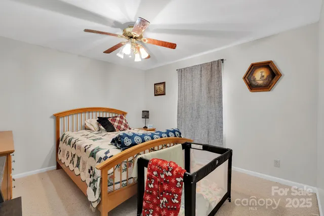 a bedroom with furniture and a baby crib