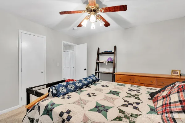 a bedroom with a bed and a chandelier