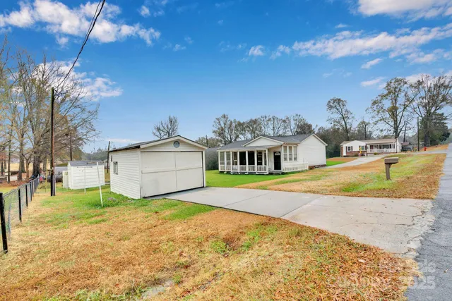 a view of an house with backyard space and balcony