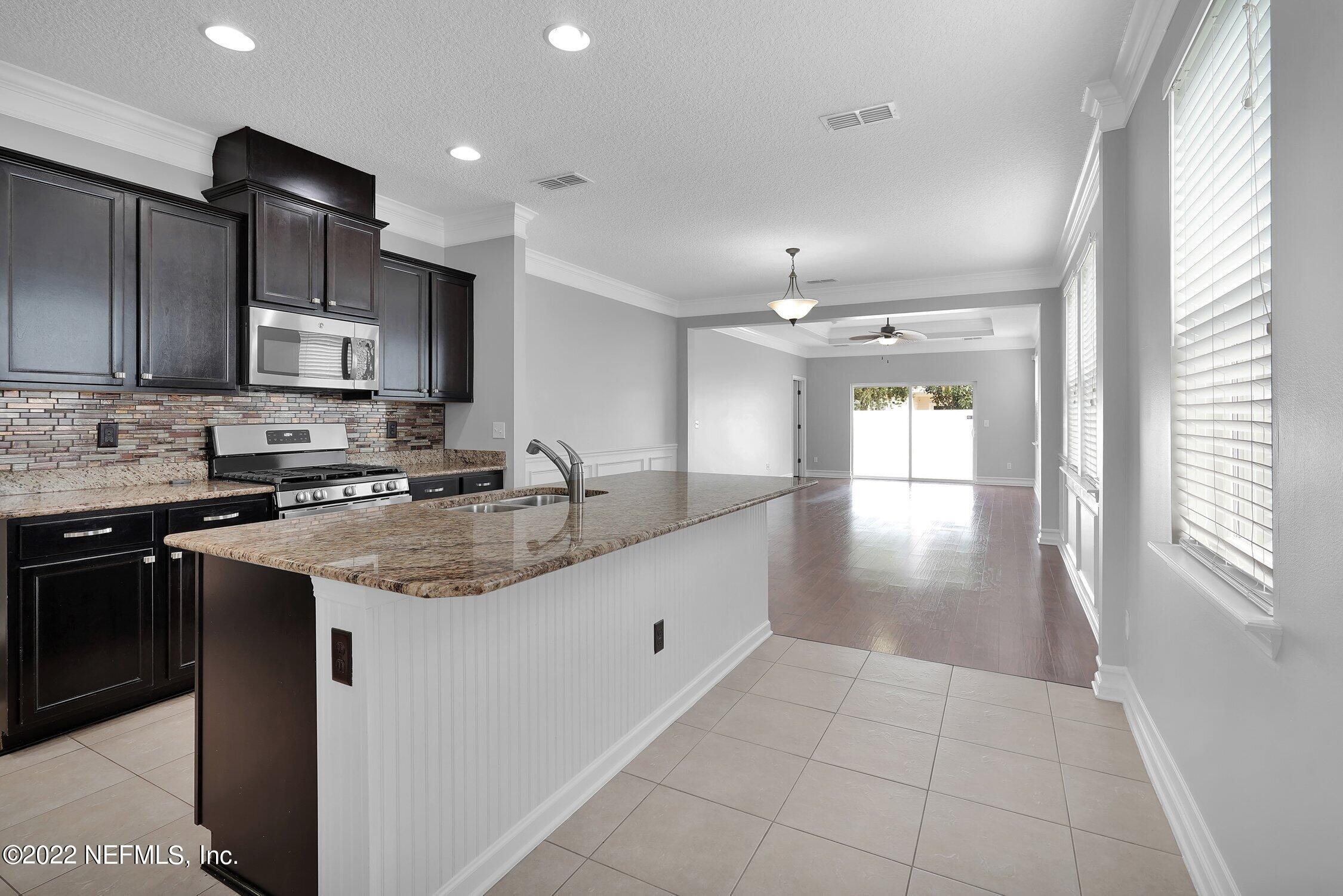 242 Taylor Ridge Avenue Ponte Vedra, FL 32081 - Photo 11 of 26 a kitchen with stainless steel appliances granite countertop a sink stove and cabinets