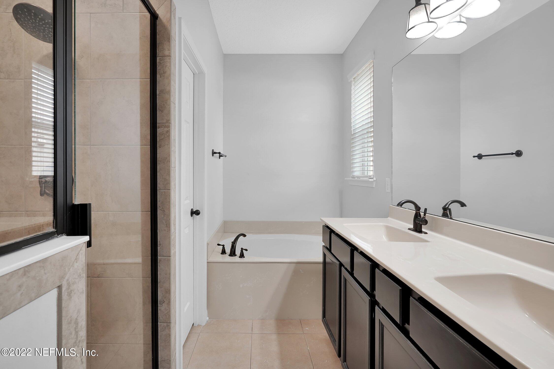 242 Taylor Ridge Avenue Ponte Vedra, FL 32081 - Photo 20 of 26 a bathroom with a sink a tub and a mirror