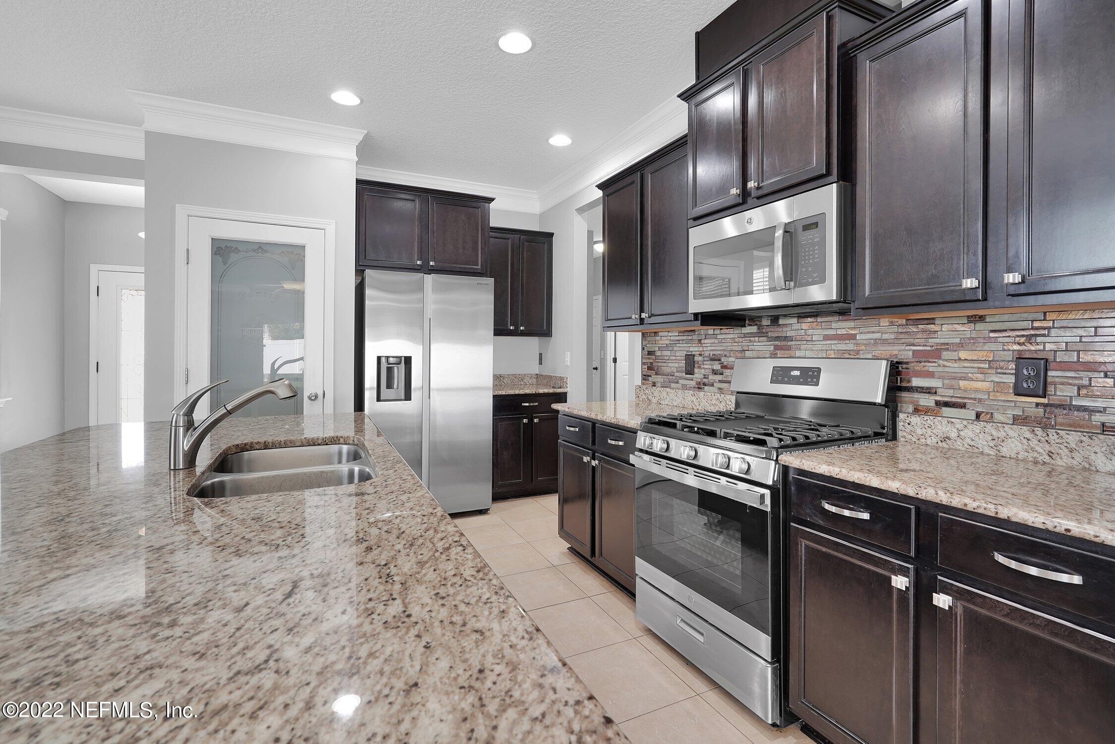 242 Taylor Ridge Avenue Ponte Vedra, FL 32081 - Photo 2 of 26 a kitchen with stainless steel appliances granite countertop a stove a sink and a refrigerator