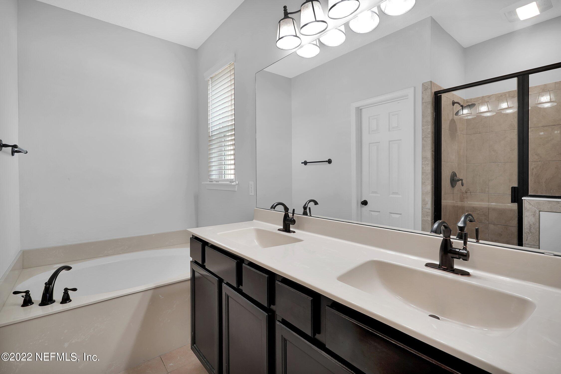 242 Taylor Ridge Avenue Ponte Vedra, FL 32081 - Photo 21 of 26 a bathroom with a sink double vanity granite tub and a mirror