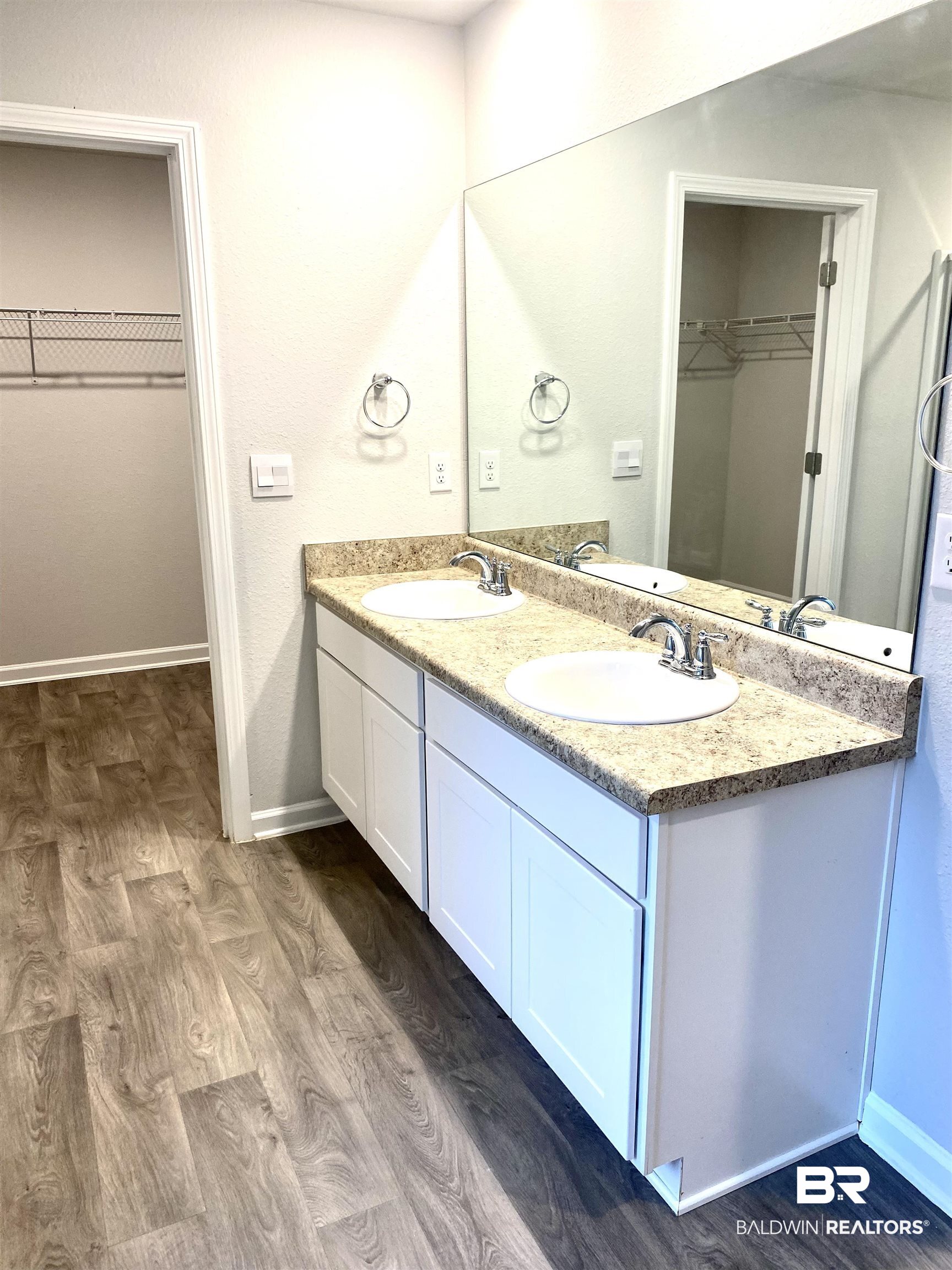 14496 Cavendish Drive Foley, AL 36535 - Photo 22 of 26 Bathroom with a walk in closet, dark wood-style flooring, and double vanity