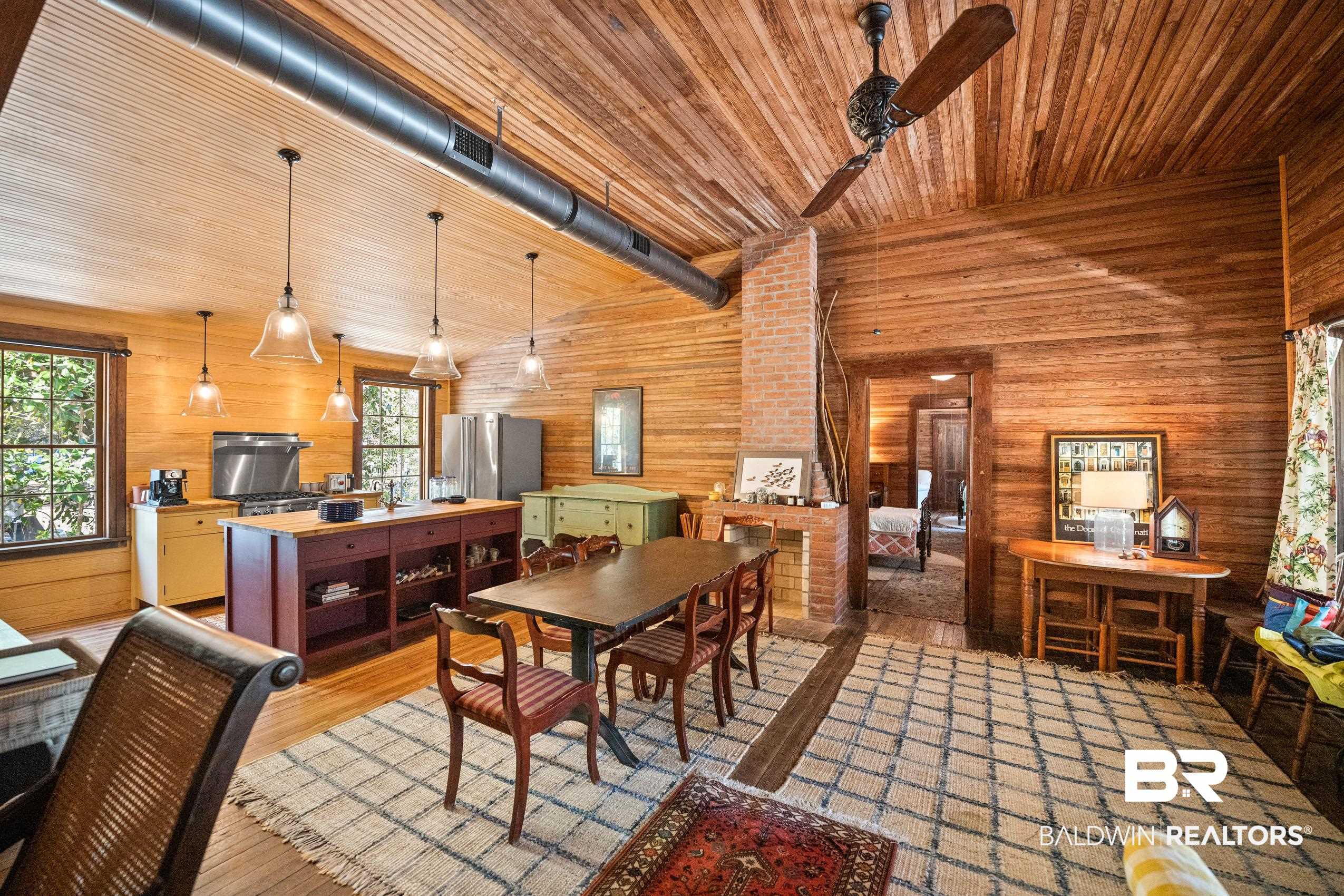 30671 Magnolia Street Elberta, AL 36530 - Photo 42 of 68 Dining room featuring wood ceiling, wood walls, lofted ceiling, visible vents, and light wood-style floors