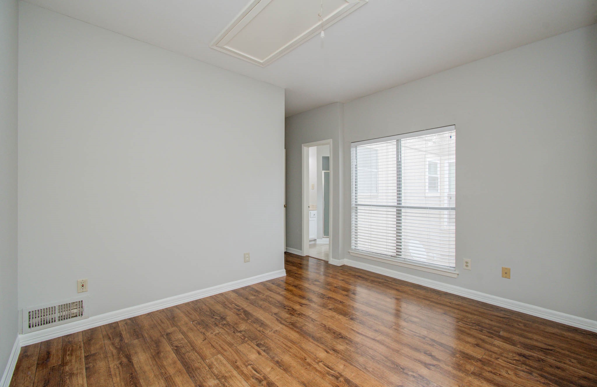 12697 Briar Patch Drive, Unit 2 Houston, TX 77077 - Photo 16 of 24 an empty room with wooden floor and windows