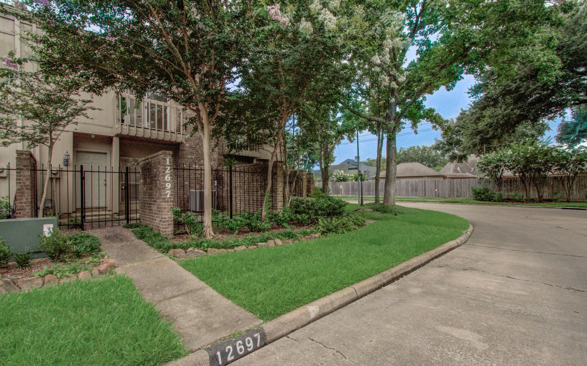 12697 Briar Patch Drive, Unit 2 Houston, TX 77077 - Photo 2 of 24 front view of a house with a yard