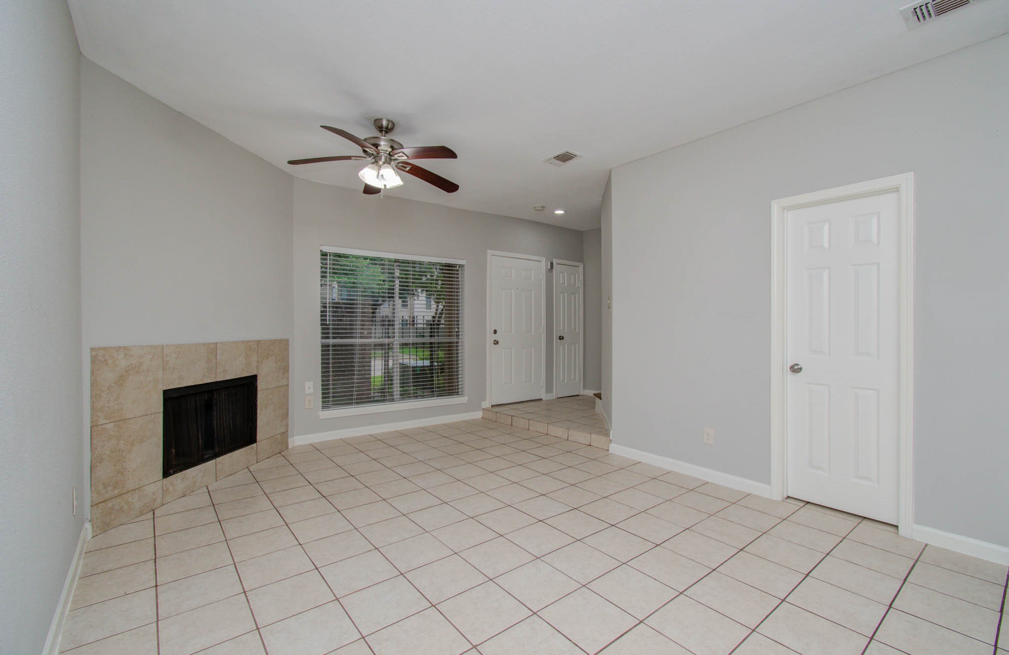 12697 Briar Patch Drive, Unit 2 Houston, TX 77077 - Photo 4 of 24 a view of an empty room with a fireplace