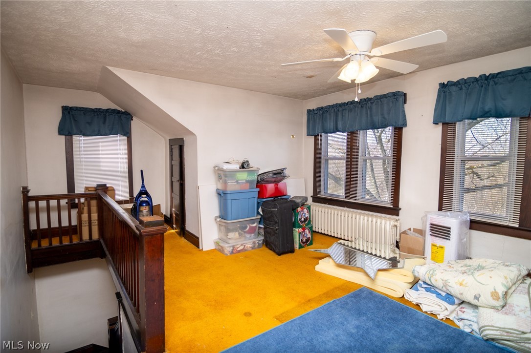 53341 Key Bellaire Road Bellaire, OH 43906 - Photo 28 of 48 Bedroom with radiator, carpet, ceiling fan, and a textured ceiling