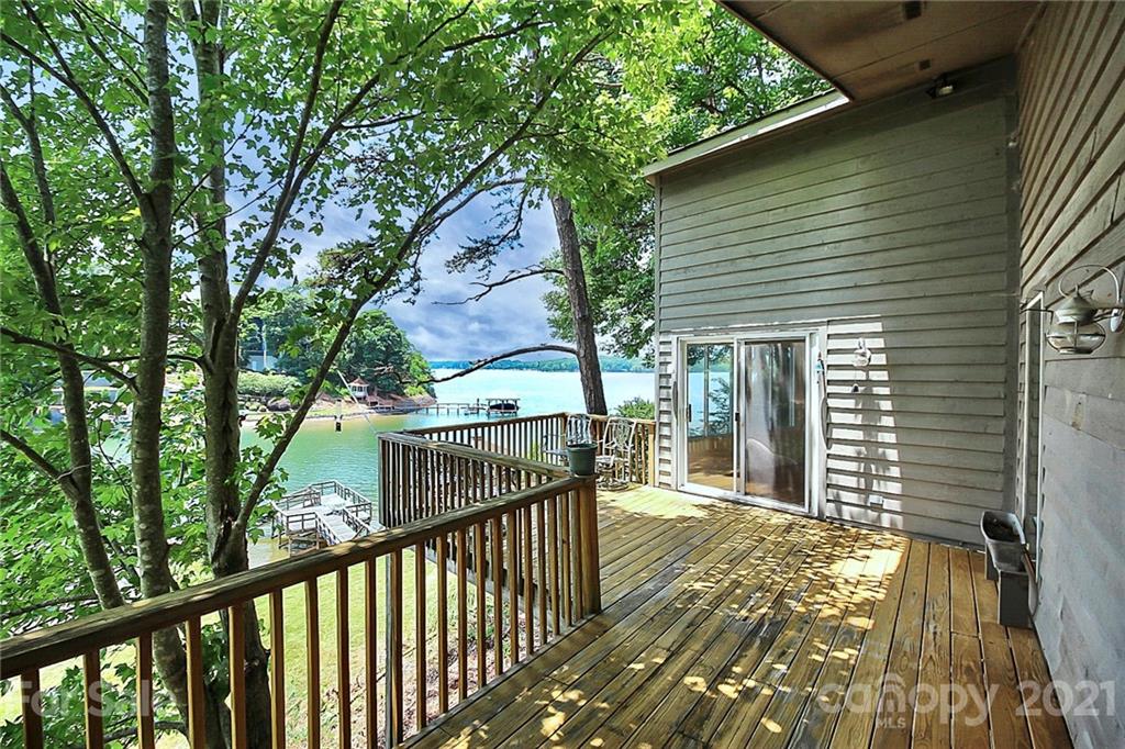 a view of a house with backyard and deck