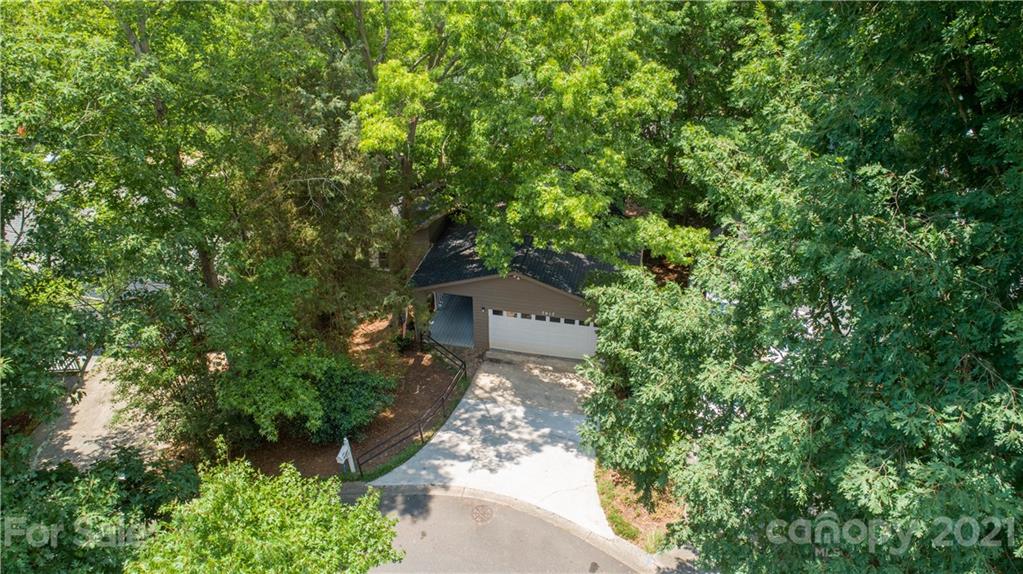 7017 Chelsea Day Lane Tega Cay, SC 29708 - Photo 2 of 48 a aerial view of a house with a yard and large trees