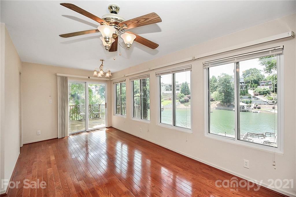 7017 Chelsea Day Lane Tega Cay, SC 29708 - Photo 14 of 48 a view of an empty room with wooden floor and a window