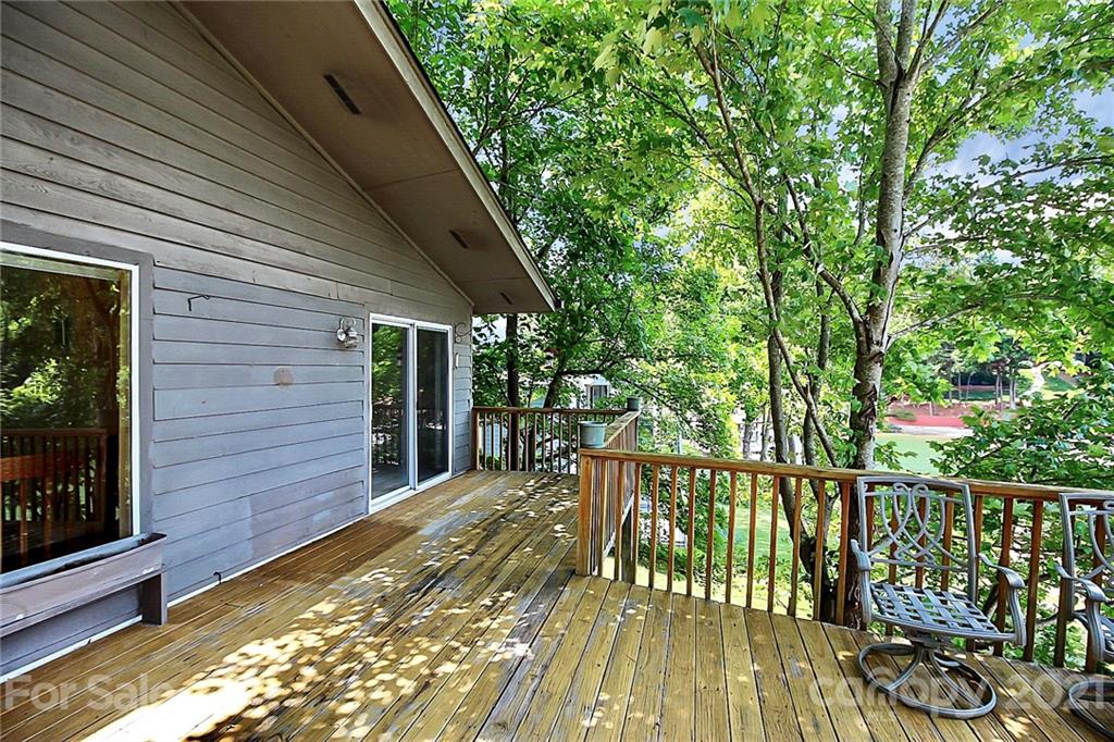 7017 Chelsea Day Lane Tega Cay, SC 29708 - Photo 33 of 48 a view of a wooden deck next to a yard