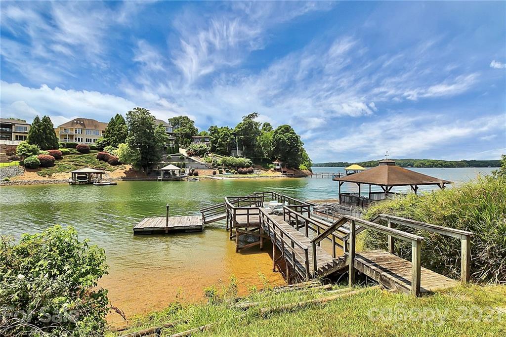 7017 Chelsea Day Lane Tega Cay, SC 29708 - Photo 39 of 48 an aerial view of a house with swimming pool patio and lake view